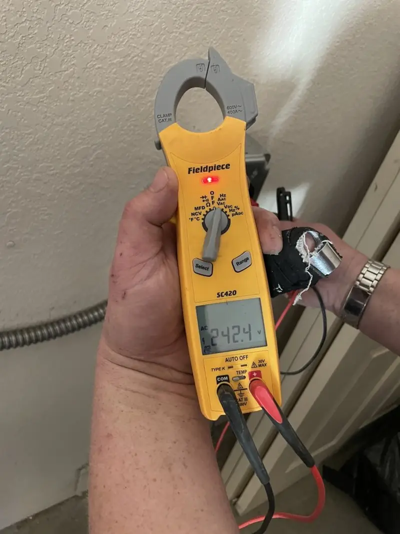 Voltage testing with clamp meter during Recessed Lighting Installation in Smithtown